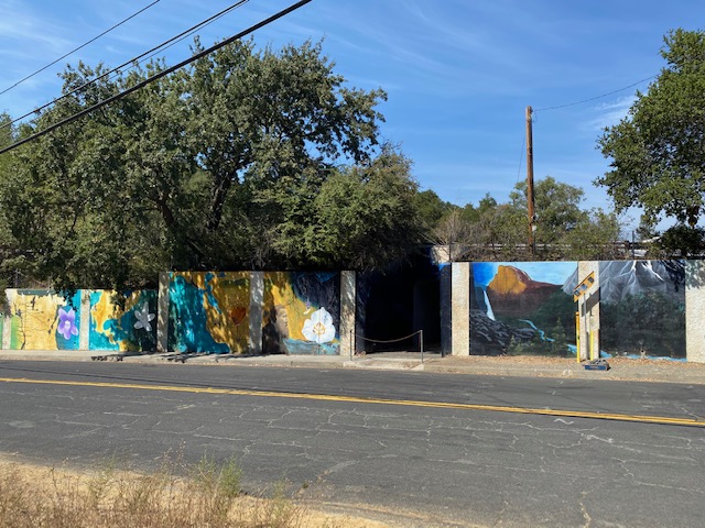 A pedestrian tunnel with a mural of John Muir