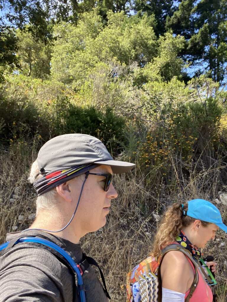 Two people wearing hats and hiking